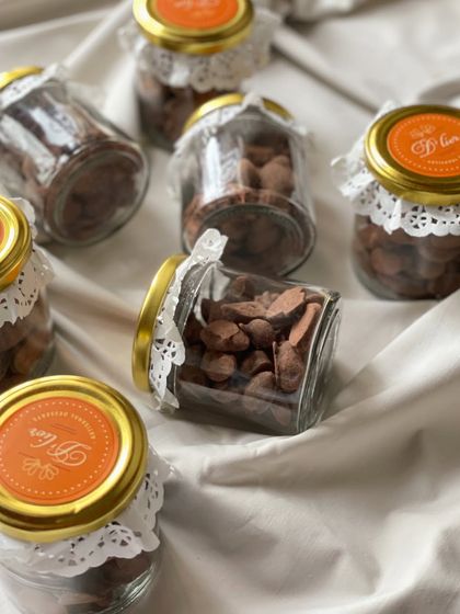 Multiple jars of our addictive choco almonds, a popular choice for bulk orders and event favors.