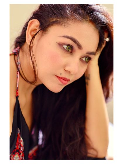 An intimate and candid-style portrait. The composition, looking in from the side, creates a sense of a private, stolen moment.