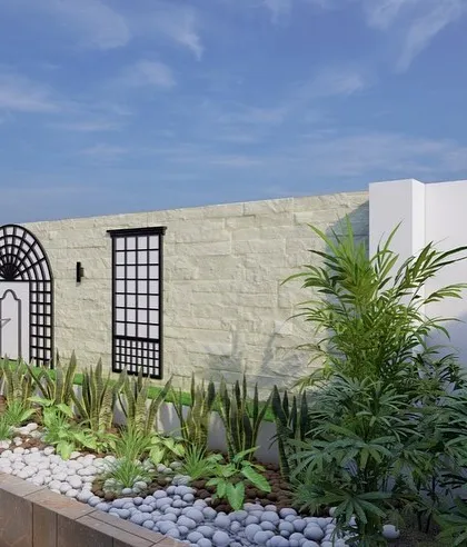 A wider view of the backyard planter box design. The wall features create visual interest along the entire length of the wall, turning a problem area into a stunning garden feature.