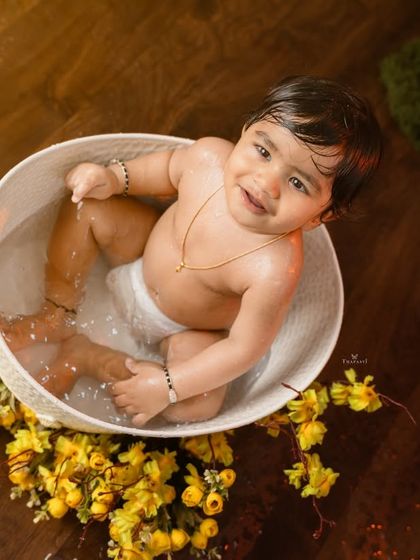 A sweet, happy smile from above as the baby enjoys the warm water in the tub.