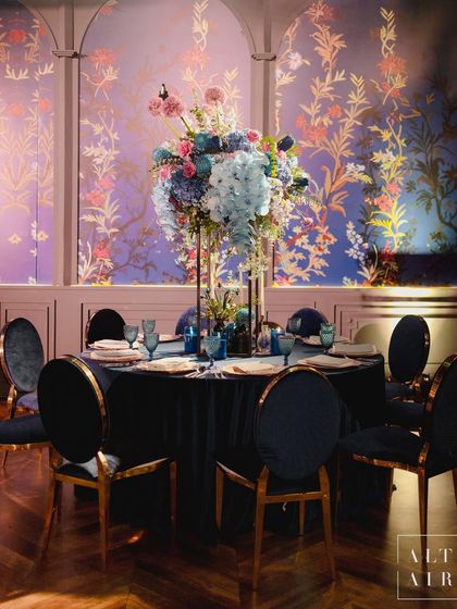 A dining table at 'Midnight Mirage', set against a custom-printed floral wallpaper. From the tiniest touch to the grandest display, each detail exuded pure beauty.