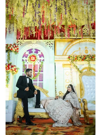 Another beautiful shot of the couple. The grand decor and their coordinated poses create a picture-perfect memory of their reception.