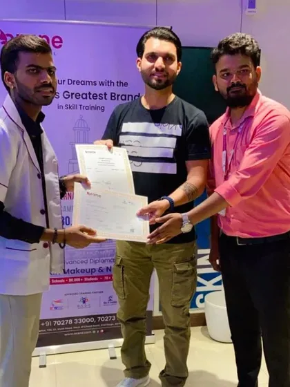 Two of our trainers awarding a certificate to a proud graduate. Our dual certification (government and international) gives our students a competitive edge in the job market.