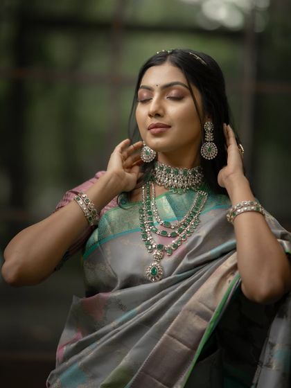 The soft, diffused light brings out the subtle shimmer and complex colors of this unique saree.