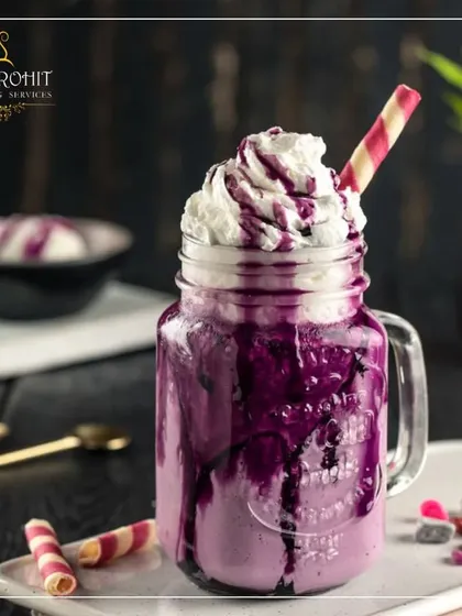 For those with a sweet tooth, I offer a range of dessert shakes that are both a drink and a treat. This Black Grape smoothie, served in a rustic mason jar, is topped with rich whipped cream and a colorful wafer straw. It's a popular choice for adding a fun and indulgent element to parties and family gatherings.