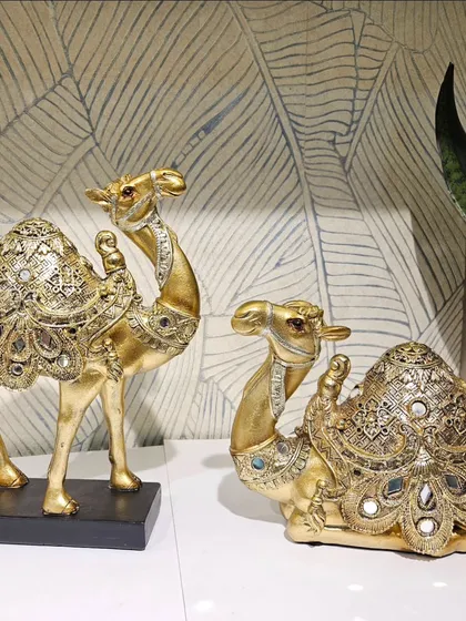 This decorative mirror-work camel pair adds a touch of royal, ethnic charm to any room.