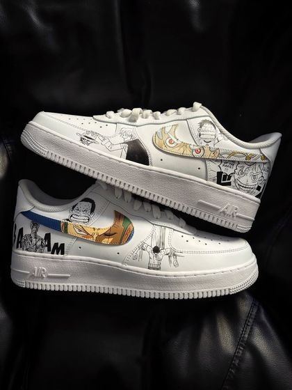 A pair shot of the One Piece manga panel sneakers, displaying the detailed artwork on both the left and right shoe.