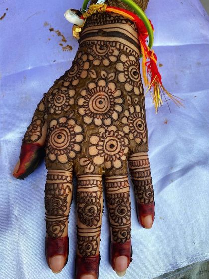 A classic full-hand design with a dense floral pattern. The fingers are also heavily detailed, and the dark fingertips provide a traditional finish.