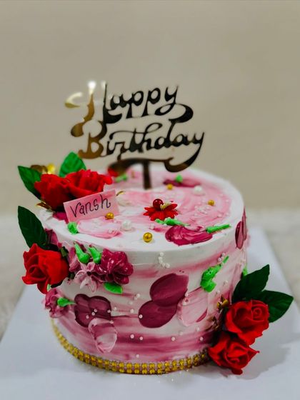 A passionate red and white cake with abstract brushstrokes and fresh red roses.
