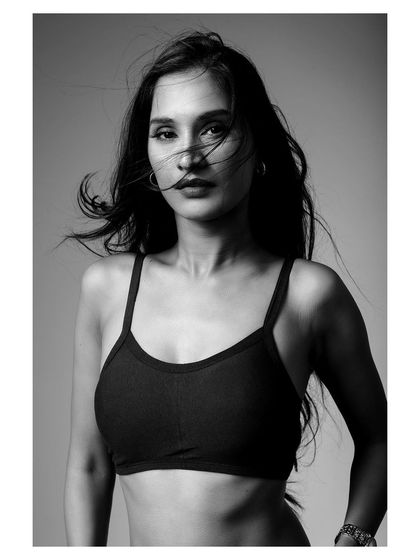 A classic black and white portrait that is both strong and beautiful, highlighting the simplicity of the activewear top.