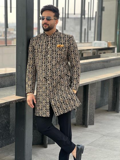 A client looking effortlessly stylish in our black and gold brocade Indo-Western jacket. It's a classic and regal choice for any festive occasion.