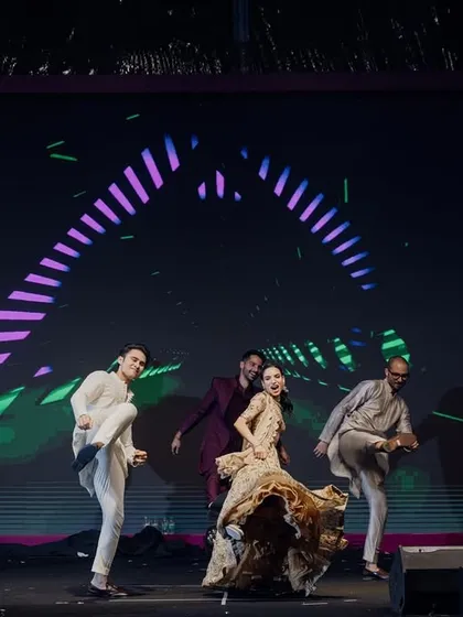 The groom joins his family on stage for a fun, energetic group performance, complete with a cool LED backdrop.