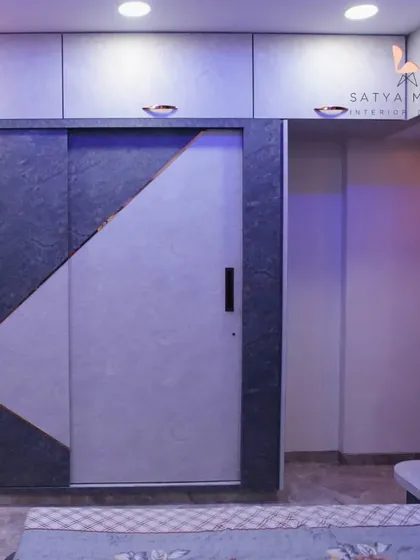 This bedroom showcases a unique sliding wardrobe with a diagonal stone-finish laminate, adding a touch of modern, edgy design.