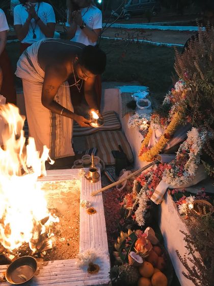 A fire puja is prepared at the base of a Tulsi plant, which is sacred in India. These rituals connect us to the ancient Vedic traditions and the five elements: earth, water, fire, air, and ether.