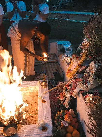 A student participates in a fire puja, a powerful ritual for purification and setting intentions. These ceremonies are an integral part of our residential training.