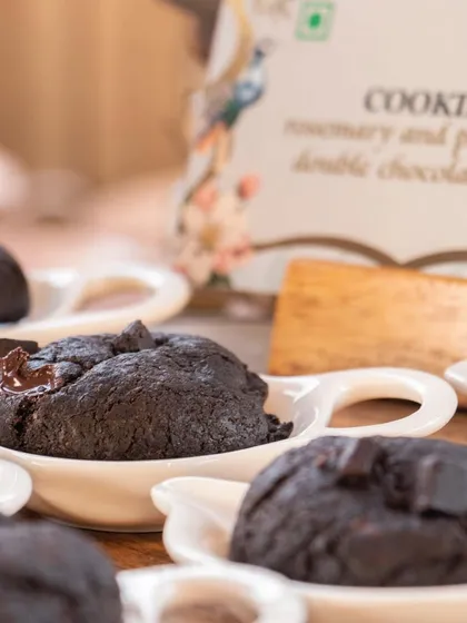 Sinful double chocolate chip cookies, soft and chewy, served in individual ceramic dishes.