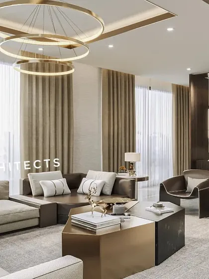 Another perspective of the Noida residence, showing the open-plan layout and connection to the adjacent areas. The combination of a sectional sofa and sleek armchairs provides versatile seating arrangements.
