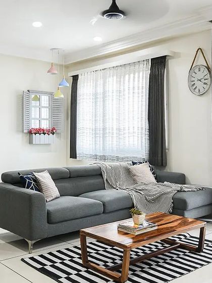 This living room was designed around a monochrome palette, creating a look that is simple, spacious, and chic. I added pops of color through small decor items and furnishings to bring personality to the black and white theme.
