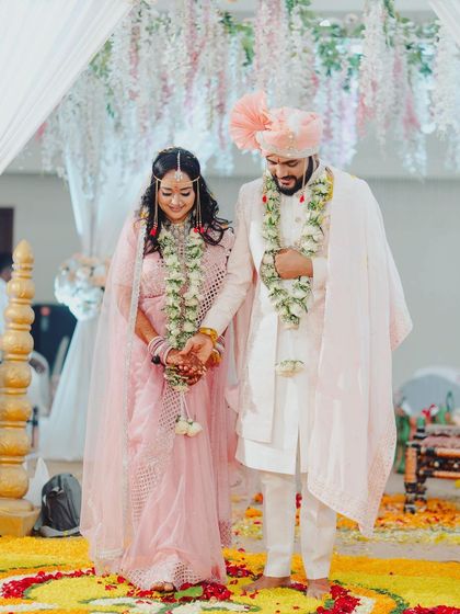 The Saptapadi, or seven steps, is a key ritual. Here, the groom's classic attire and polished look are perfect for this sacred and photogenic moment.