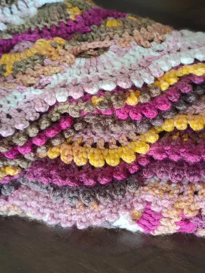 A folded view of the Virus Shawl, highlighting the rich texture and color changes.