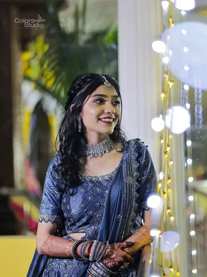 A lovely portrait of the bride smiling, with a backdrop of twinkling fairy lights.