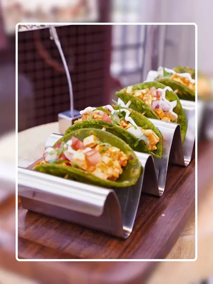 We bring global flavors to your event with our international appetizer stations. These vibrant mini tacos are filled with fresh ingredients and served in a stylish metal holder, offering a delicious and convenient bite for guests.