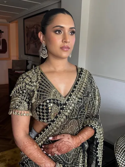 Another angle of Shanel's welcome dinner look. The makeup is perfectly balanced, with strong eyes and a neutral lip, allowing her intricate outfit to shine.