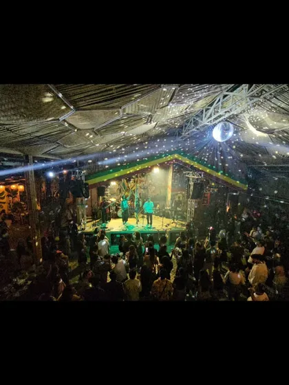 A wide shot of a packed house at The High Spirits Cafe. The disco ball, the lights, and the crowd all came together for an incredible night of live music.