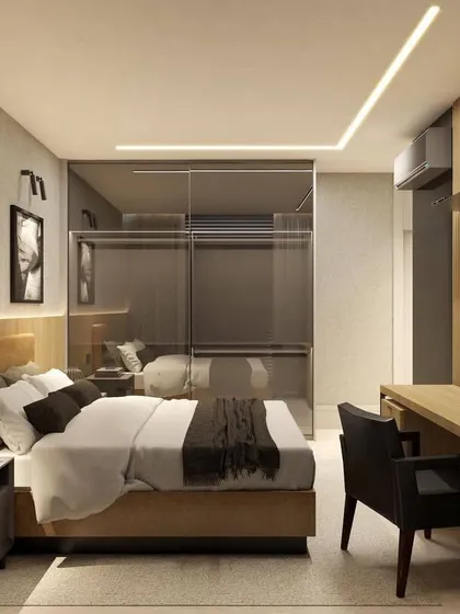 This view shows the integrated study desk and TV unit in the bedroom. The fluted wood paneling continues, creating a cohesive and stylish look.