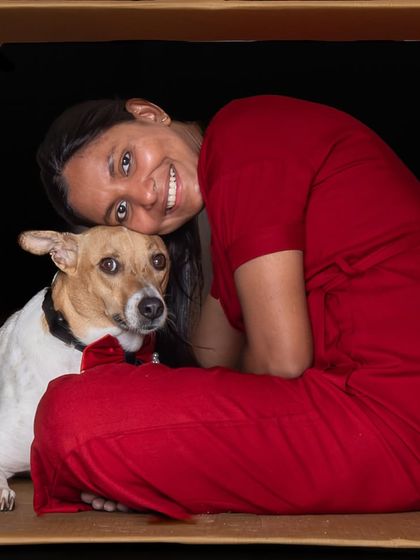 A heartwarming "in the box" portrait of a woman and her dog from a fun group shoot. It showcases a beautiful, quiet connection amidst the playful theme.