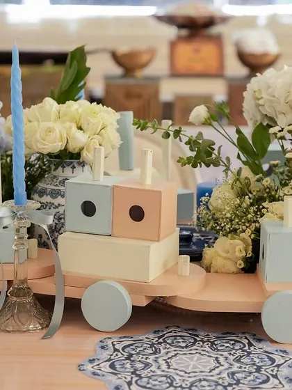 A wooden toy train serves as a playful and unique centerpiece.