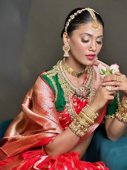 Another angle of the South Indian bridal look, focusing on the delicate hair accessories. The neat bun is decorated with a traditional gold matha patti, creating an elegant and authentic style for a bridal campaign.