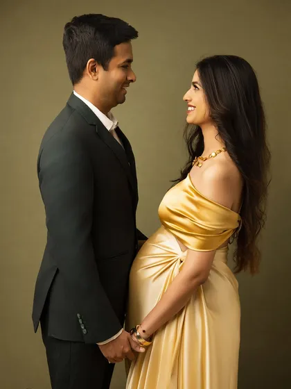 A classic and elegant couple's portrait. The couple gazes at each other, their smiles reflecting their joy and love, all while looking effortlessly chic in formal wear.