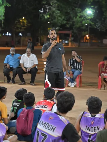 An organizer addresses the young players before the awards ceremony, sharing words of encouragement.