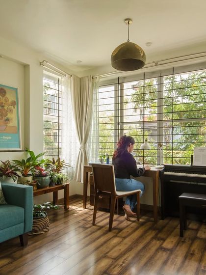 A new home office addition, designed to be a creative sanctuary. Large windows provide an inspiring view of the garden, while the wooden floor and comfortable furniture make it a productive and pleasant place to work.