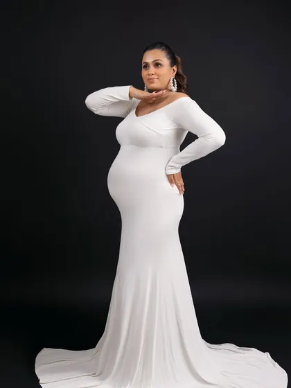A confident and powerful pose, showcasing the beautiful silhouette of pregnancy.