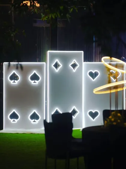 Another view of the illuminated playing card installation, a popular photo spot for guests at the Diwali celebration.