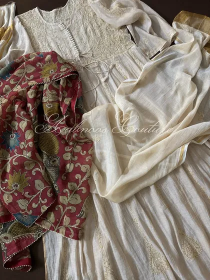 The complete ensemble laid flat, showing the Anarkali with both its matching dupatta and the optional Kalamkari dupatta.