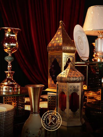 Ornate brass lanterns and luxury tableware as part of a lavish, Moroccan-themed decor setup.