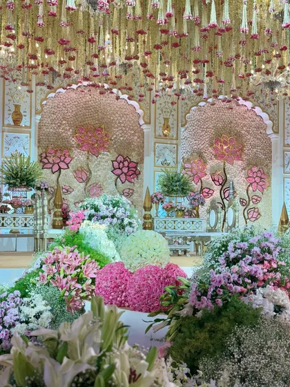 A view of the floral fairytale mandap, with its cascading jasmine ceiling and lush blossoms, creating a dream-like atmosphere for the wedding ceremony.