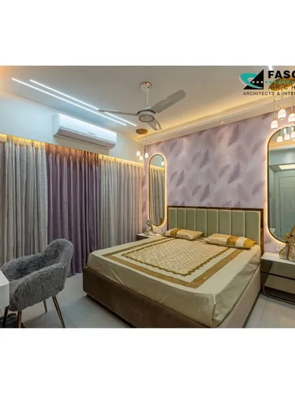 A serene bedroom in Seawoods with a soft green headboard and elegant, backlit oval mirrors. The design uses a gentle color palette and soft lighting to create a peaceful and stylish retreat.
