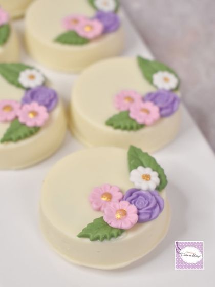 A close-up of the floral chocolate-dipped Oreos. It's the small details that bring a whole dessert table together.