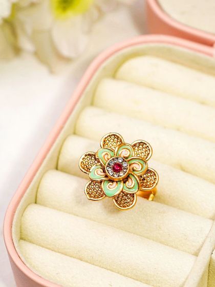A traditional floral ring styled in a pink jewellery box. The context of the box adds a layer of storytelling, suggesting it as a gift item.