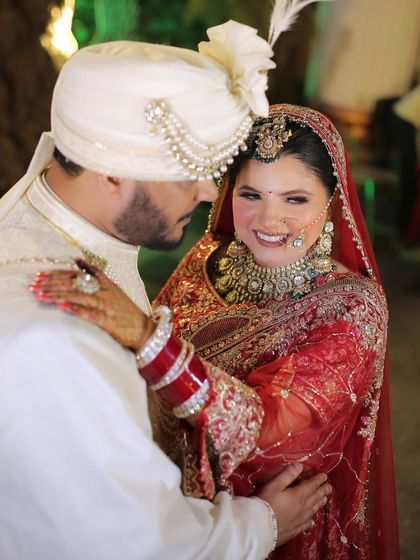 A candid moment between the happy couple. Her makeup is designed to look beautiful from every angle, with a soft glow that looks amazing in photos.