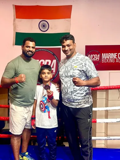 Little champion Devansh Gayake with his coaches, holding his bronze medal. We believe in celebrating every victory, big or small.