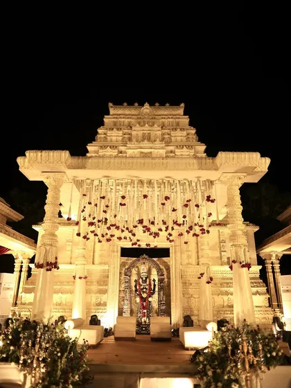 We recreated the grandeur of a South Indian temple for this wedding mandap. The intricate architecture, lit beautifully against the night, provided a sacred and awe-inspiring space for the couple to take their vows, blending tradition with theatrical design.