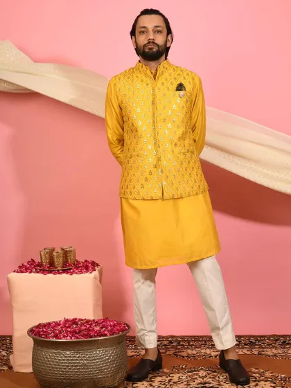 This vibrant yellow Nehru jacket is designed to make a statement. The subtle foil print adds a touch of festivity, making it a perfect choice for a Haldi ceremony or a bright Diwali look.