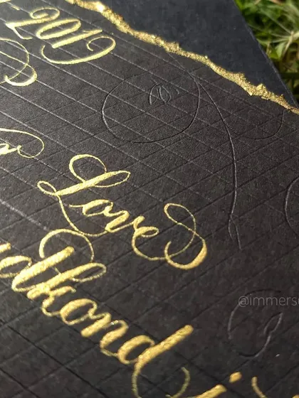 This close-up shows the detail in the pointed pen calligraphy and the subtle blind-embossed flourishes in the background. Every word is written with care to capture the emotion of the message.