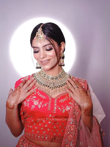 A close-up showcasing the makeup and jewellery with our two-tone pink lehenga. The heavy necklace and maang tikka are perfect for a royal bridal aesthetic.