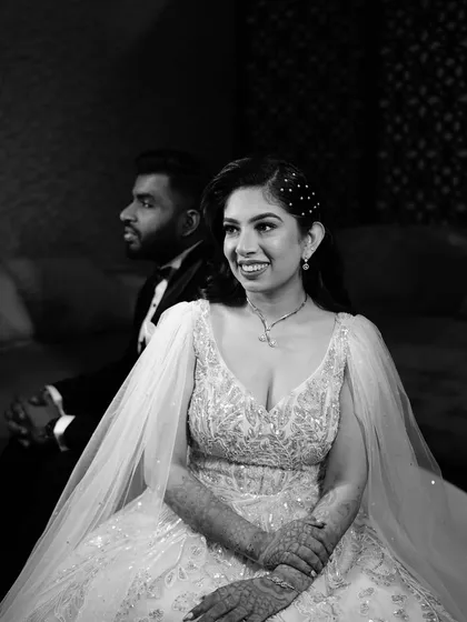 A timeless black and white portrait. This classic shot highlights her beautiful smile and the elegant details of her gown and makeup.